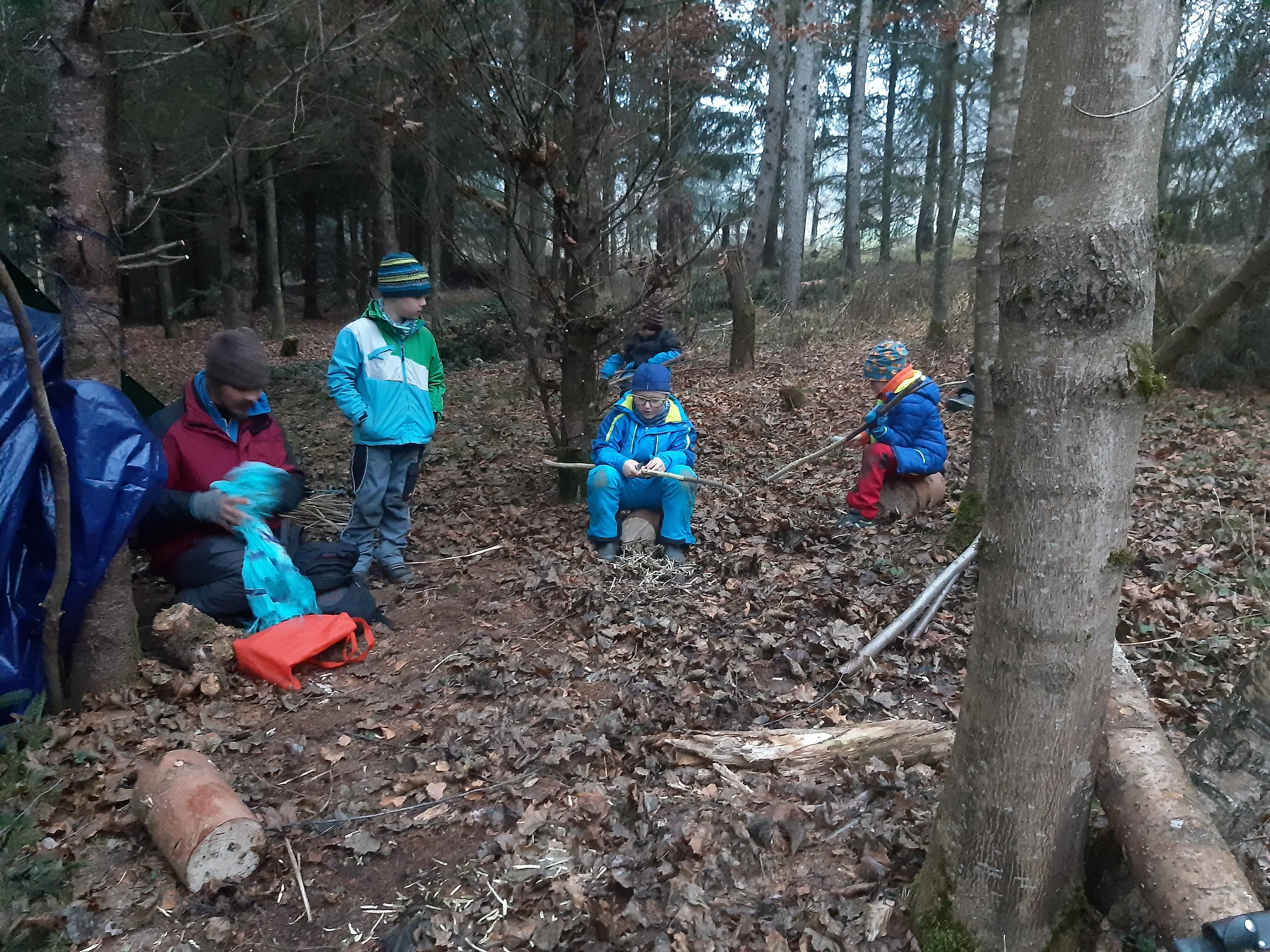 Kinder spielen im Wald rund um ihr Lager